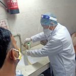 The doctor is conducting a urine test on the patient.